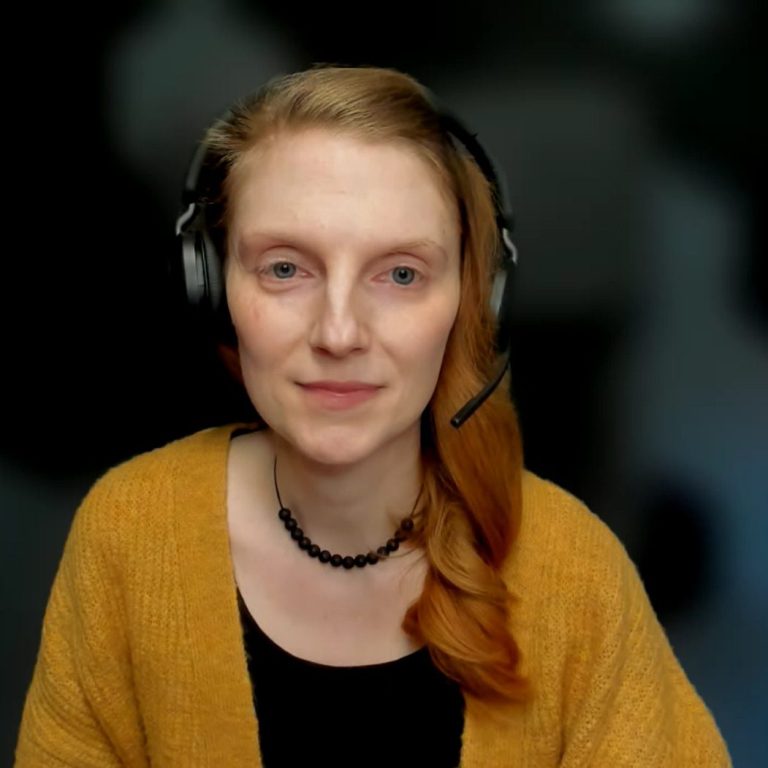 Online-Trauerbegleitung Sitzung Person spricht in einem Videoanruf mit einer lächelnden Frau auf einem Laptop.